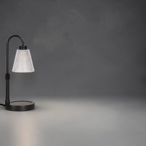 Table lamp with a white textured shade on a dark gray background