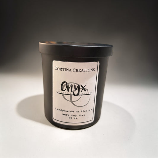 Black candle container with 'Cortina Creations Onyx' label on a gray background